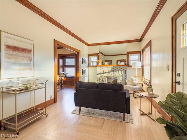 living room with crown molding, a fireplace, and light parquet floors