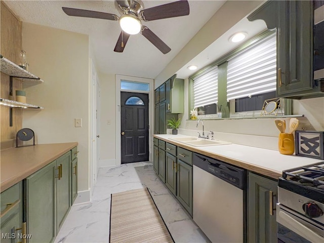 kitchen with ceiling fan, green cabinets, sink, and stainless steel appliances