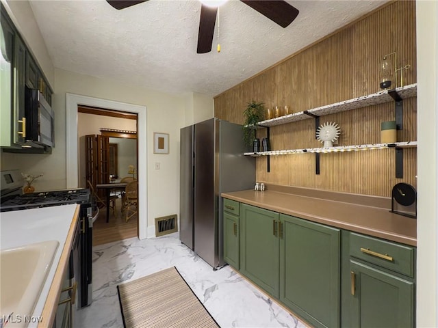 kitchen featuring appliances with stainless steel finishes, green cabinetry, and ceiling fan