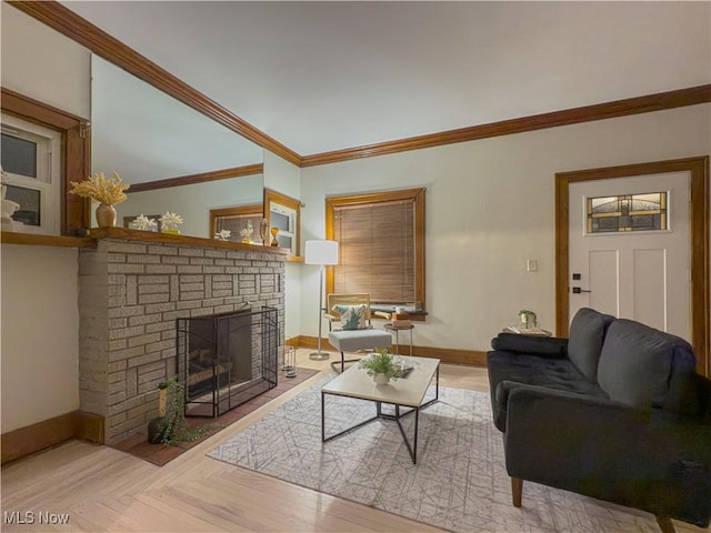 living room featuring crown molding, a fireplace, and light parquet flooring