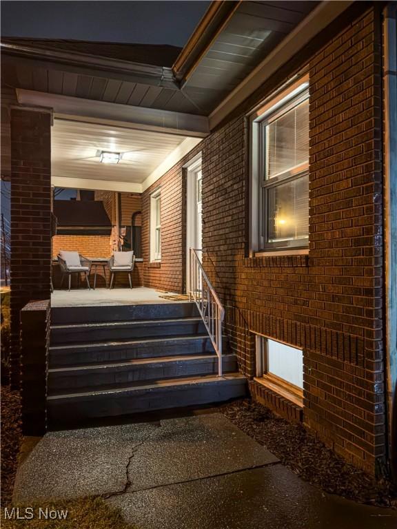 interior space featuring brick wall