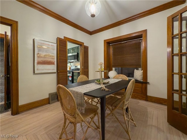 dining area with ornamental molding and light parquet floors