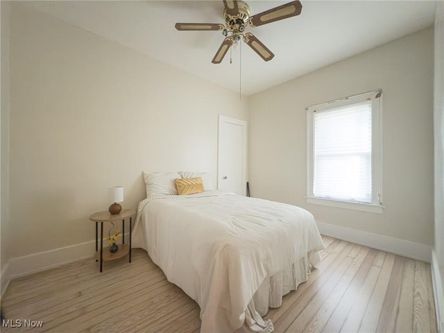 bedroom with light hardwood / wood-style floors and ceiling fan