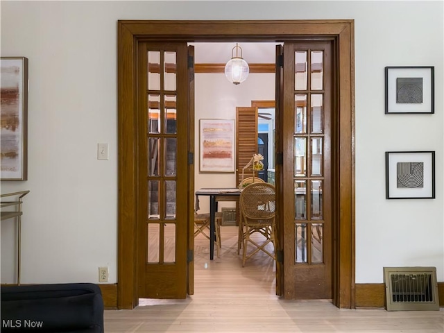 entryway featuring french doors and light wood-type flooring