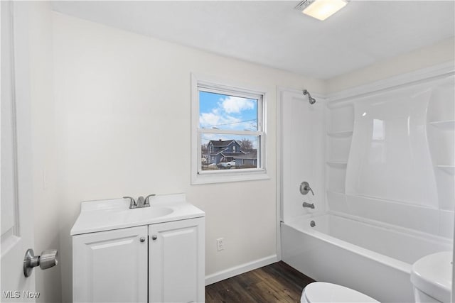 full bathroom featuring hardwood / wood-style floors, vanity, toilet, and shower / tub combination