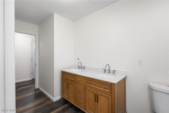 bathroom featuring hardwood / wood-style floors, vanity, and toilet