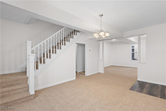 interior space with carpet floors and a notable chandelier