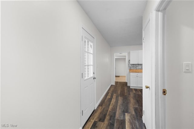 hallway with dark wood-type flooring