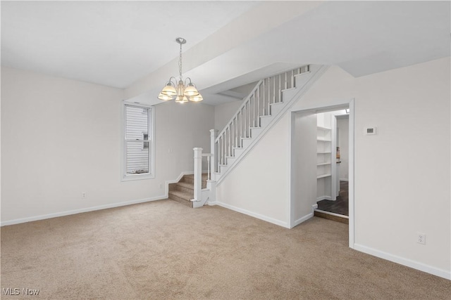 unfurnished living room with light carpet and a notable chandelier