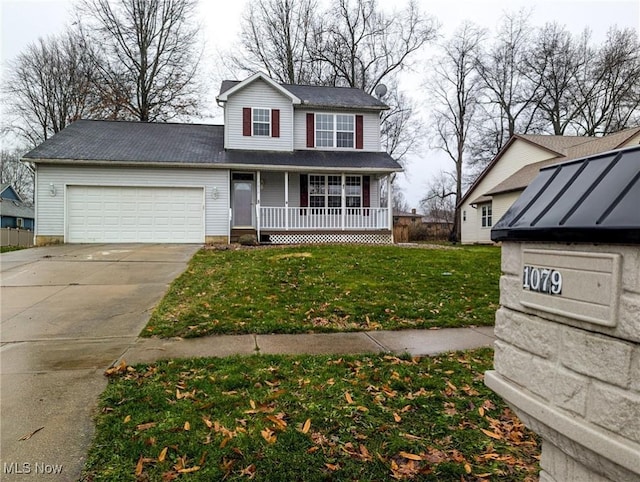 front facade with covered porch, a garage, and a front lawn