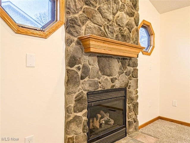 interior details featuring carpet and a fireplace