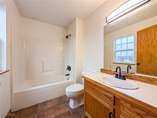 full bathroom featuring a textured ceiling, vanity, bathtub / shower combination, and toilet