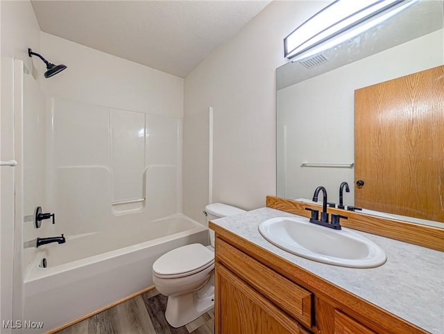 full bathroom featuring toilet, vanity, tub / shower combination, and hardwood / wood-style flooring