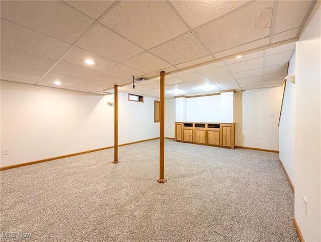 basement with carpet flooring and a drop ceiling