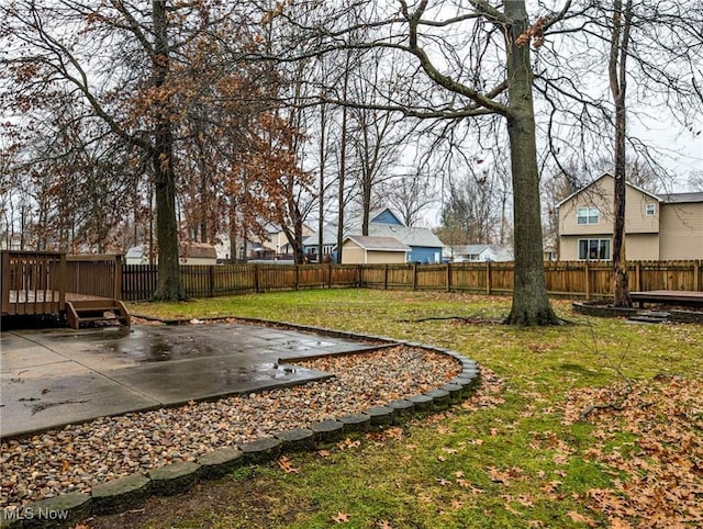 view of yard featuring a patio area and a wooden deck