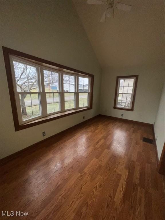 interior space featuring dark hardwood / wood-style floors, high vaulted ceiling, and ceiling fan