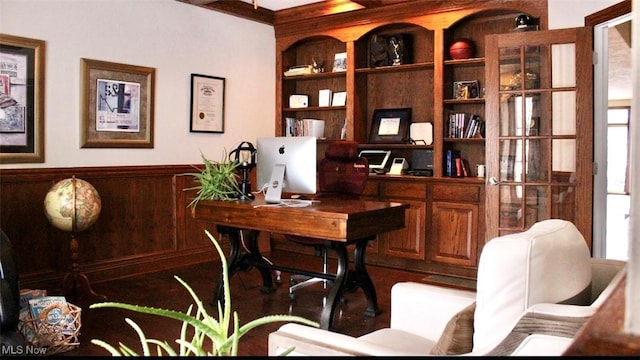 home office with built in shelves and plenty of natural light