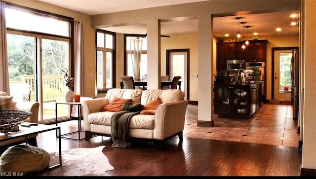 living room featuring a chandelier, hardwood / wood-style flooring, and a wealth of natural light