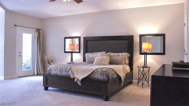 bedroom featuring light carpet, multiple windows, access to outside, and ceiling fan