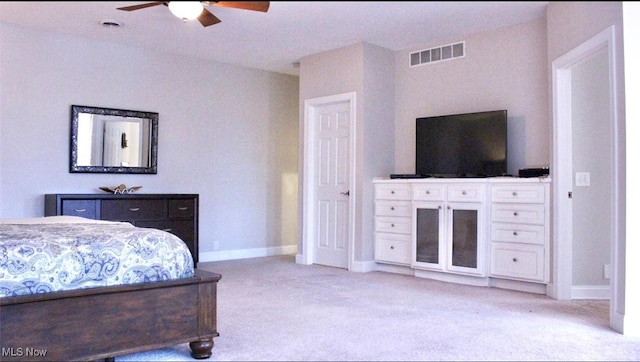 bedroom with ceiling fan and light colored carpet