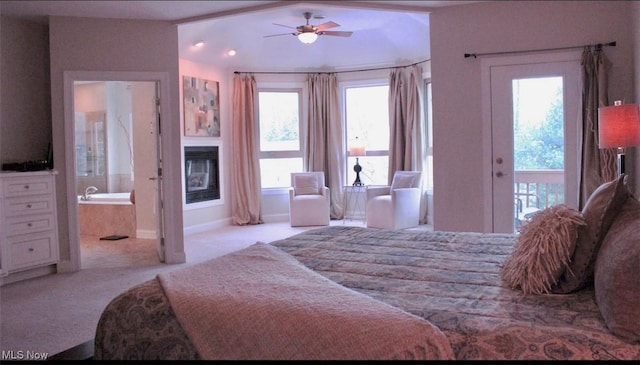 bedroom with access to exterior, ceiling fan, ensuite bath, and light colored carpet