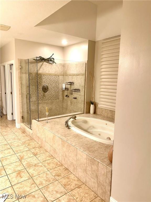 bathroom featuring tile patterned floors and separate shower and tub