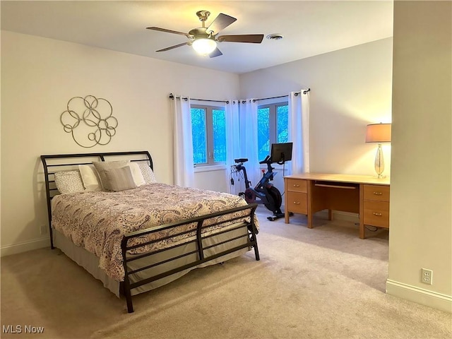 bedroom with ceiling fan and light colored carpet