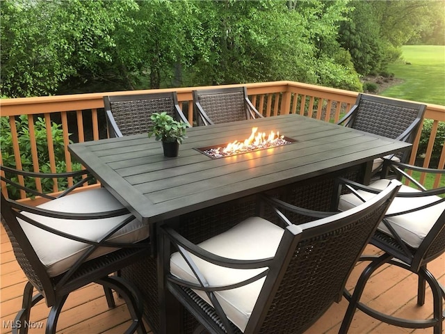 wooden terrace featuring an outdoor fire pit