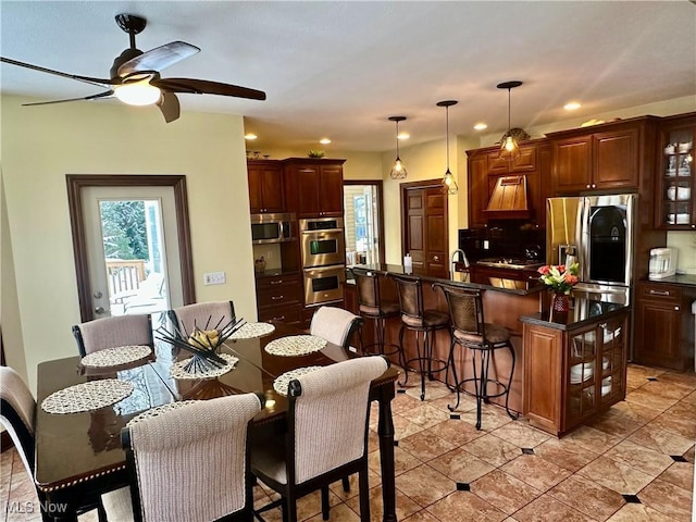 tiled dining room with ceiling fan and a healthy amount of sunlight