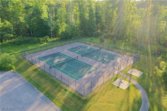 view of sport court featuring a lawn