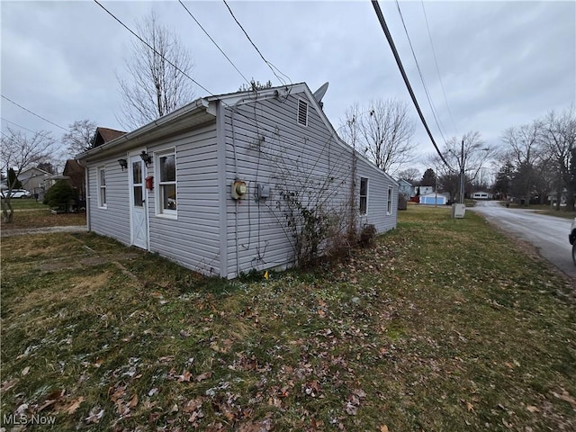 view of property exterior with a yard