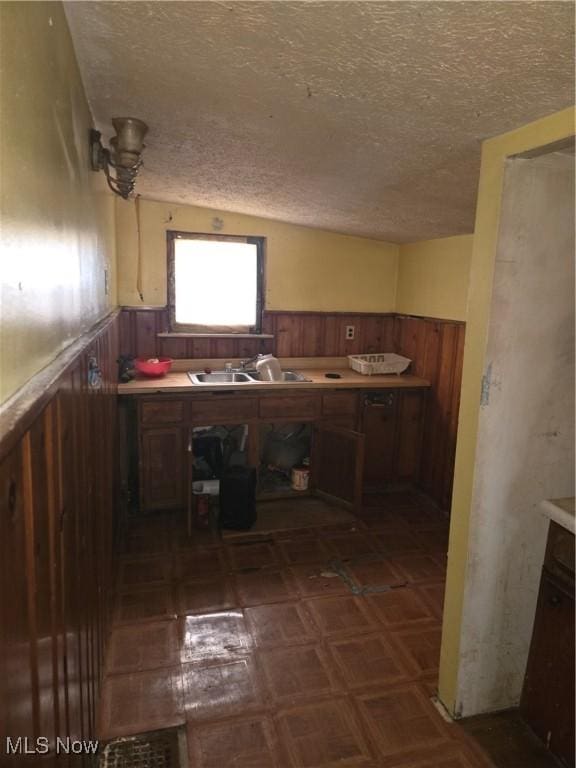 kitchen featuring a textured ceiling and sink