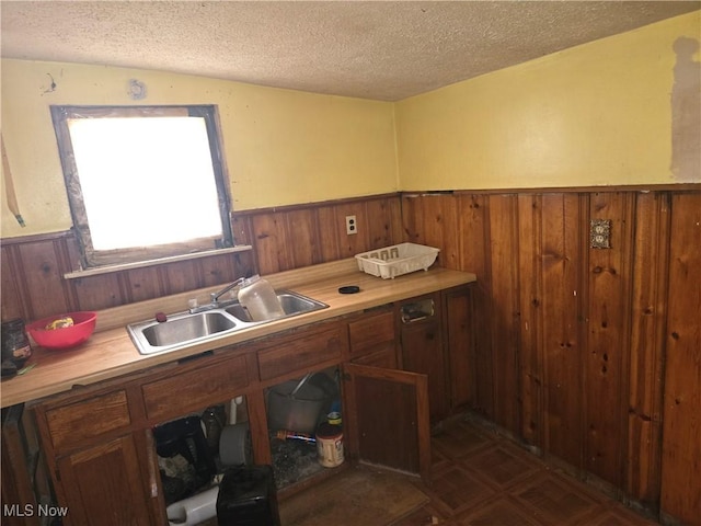 kitchen featuring a textured ceiling and sink