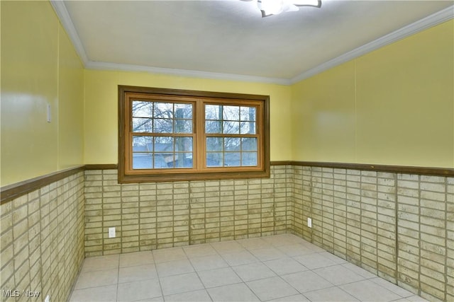 empty room featuring tile walls and crown molding