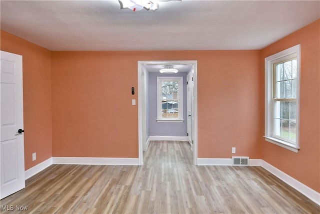 spare room featuring light hardwood / wood-style flooring