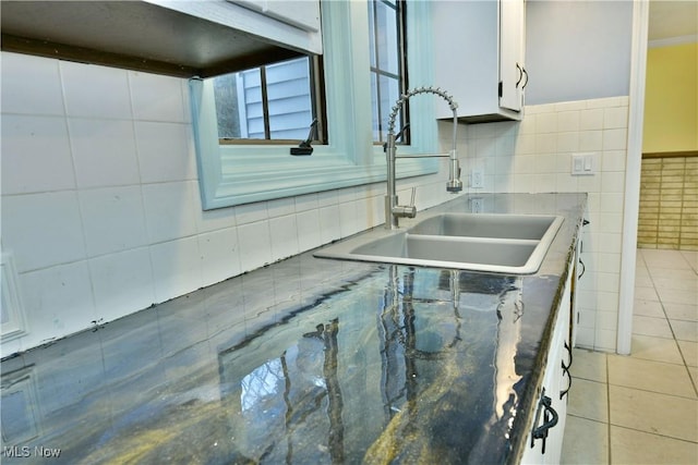 details featuring white cabinetry and sink