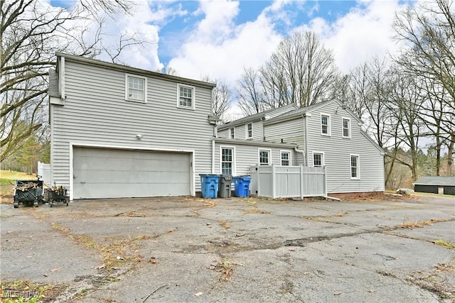 rear view of property with a garage