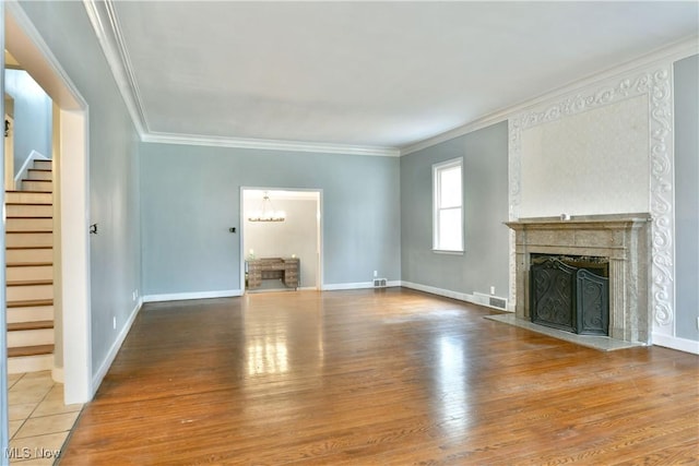 unfurnished living room with hardwood / wood-style flooring and ornamental molding