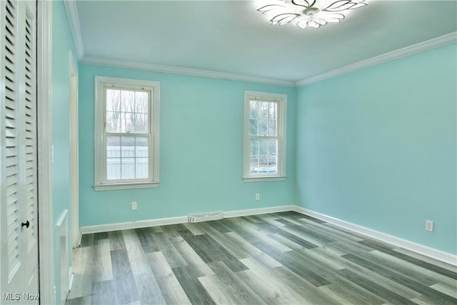 unfurnished bedroom with light hardwood / wood-style floors, ornamental molding, and multiple windows