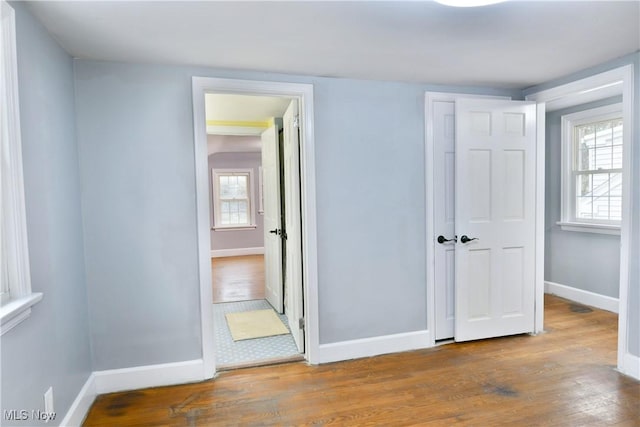 unfurnished bedroom with a closet and hardwood / wood-style floors