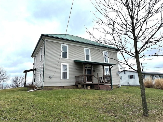 back of property featuring a yard