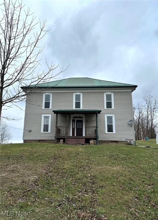 rear view of house with a yard