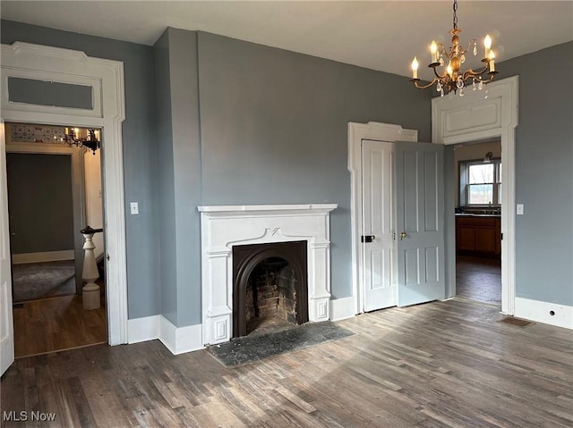 unfurnished living room with a notable chandelier and dark wood-type flooring