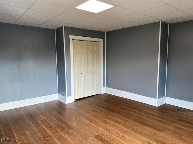 unfurnished bedroom featuring hardwood / wood-style floors and a closet