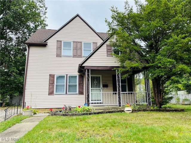 view of front of home with covered porch and a front lawn