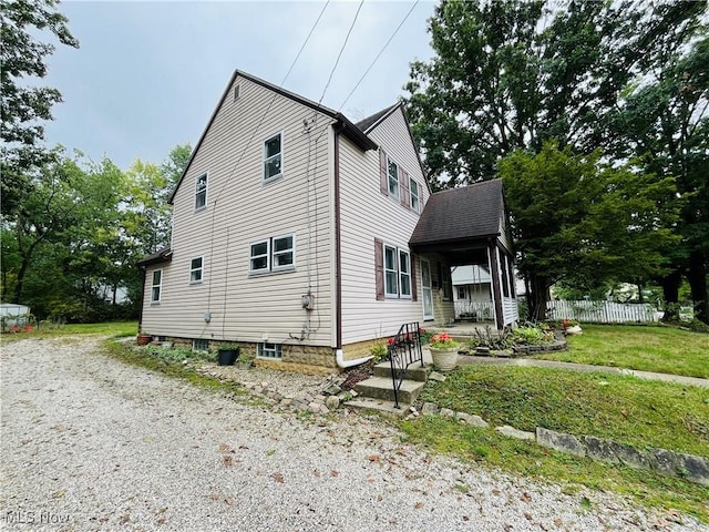 view of side of property featuring a porch