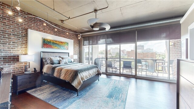 21 Furnace St Unit 705, Akron, OH 44308 - bedroom featuring brick wall, access to exterior, wood finished floors, multiple windows, and a view of city