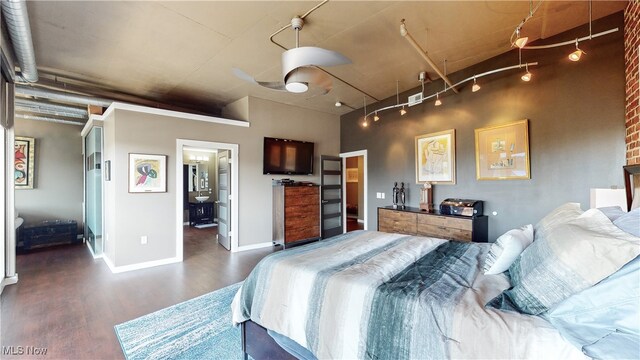 21 Furnace St Unit 705, Akron, OH 44308 - bedroom featuring dark wood-style floors, track lighting, and baseboards