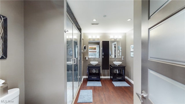 21 Furnace St Unit 705, Akron, OH 44308 - full bath featuring wood finished floors, toilet, vanity, a shower stall, and baseboards