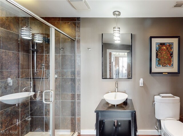 21 Furnace St Unit 705, Akron, OH 44308 - full bathroom with toilet, vanity, a stall shower, and baseboards